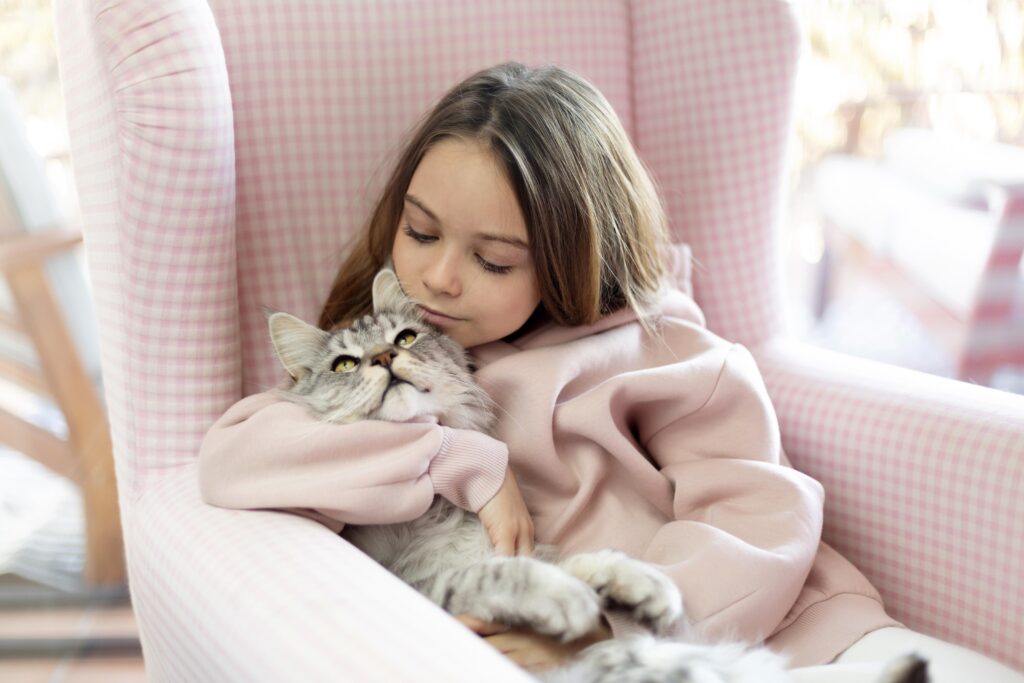 Cat purring effect on humans: a person sitting with a cat on their lap for emotional support