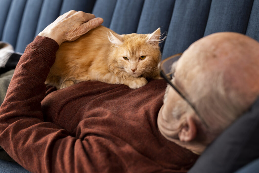 Elderly person with therapy cat lying on their chest, showing the calming effect of pet therapy for emotional support in hospice care.