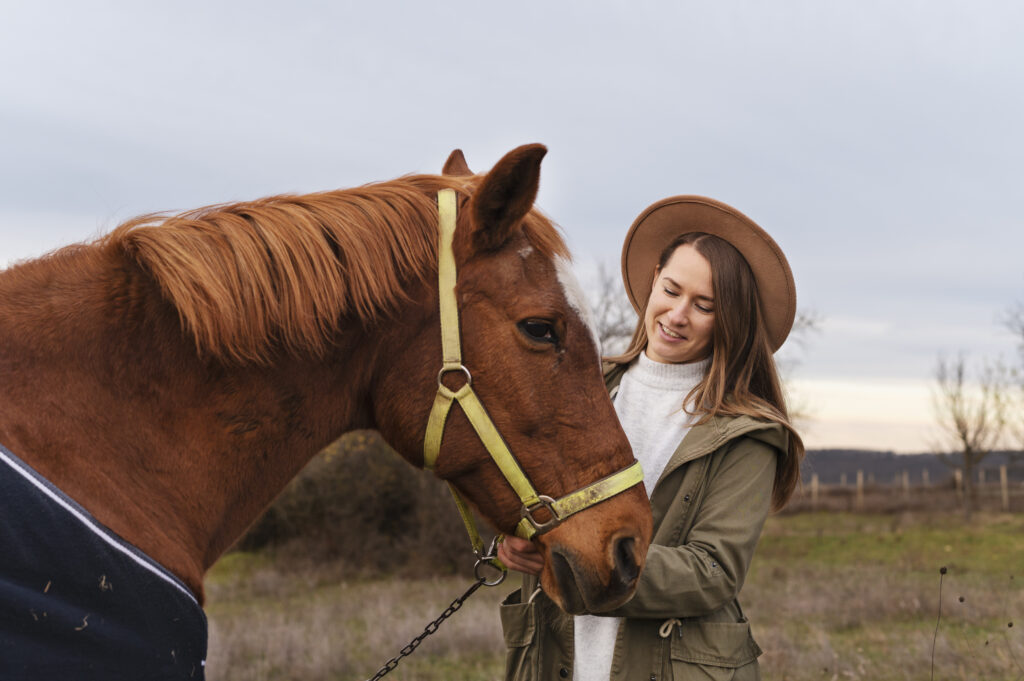 Equine-assisted therapy: Woman interacting with a horse, demonstrating the role of horses in animal-assisted therapy (AAT).