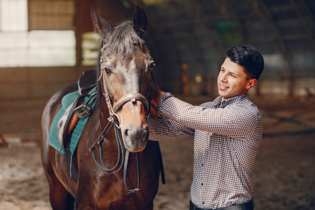 Equine-assisted therapy participant grooming a horse for bonding