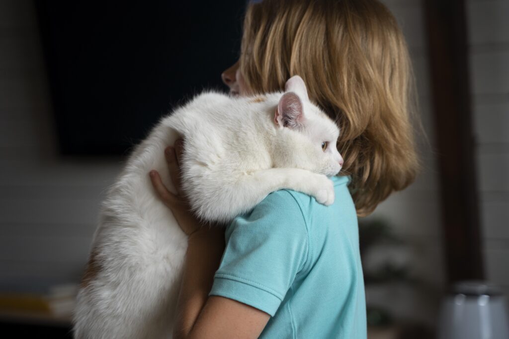 Child holding a therapy cat